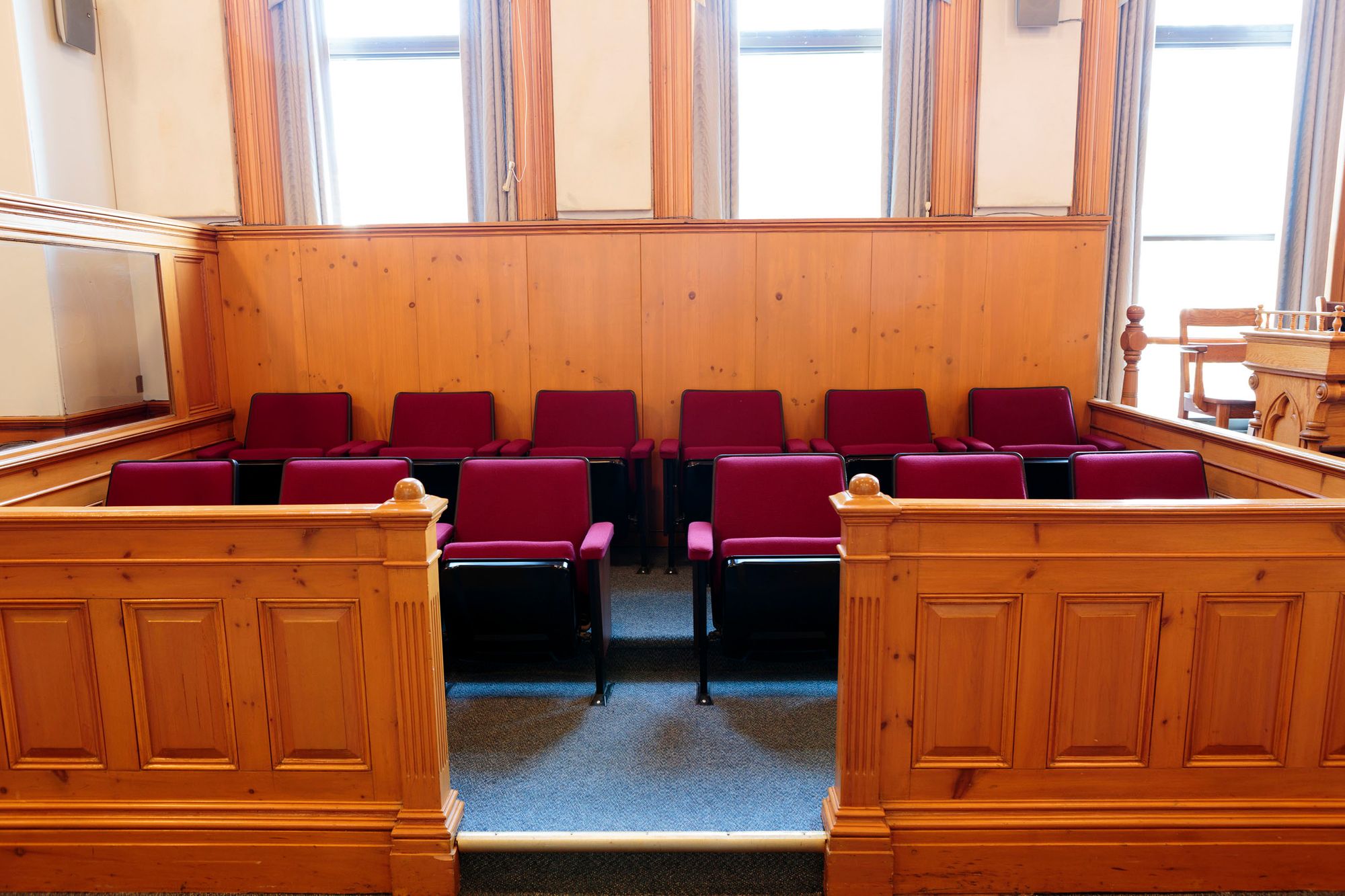 Empty jury box. Jury selection can be done with online video conferencing.